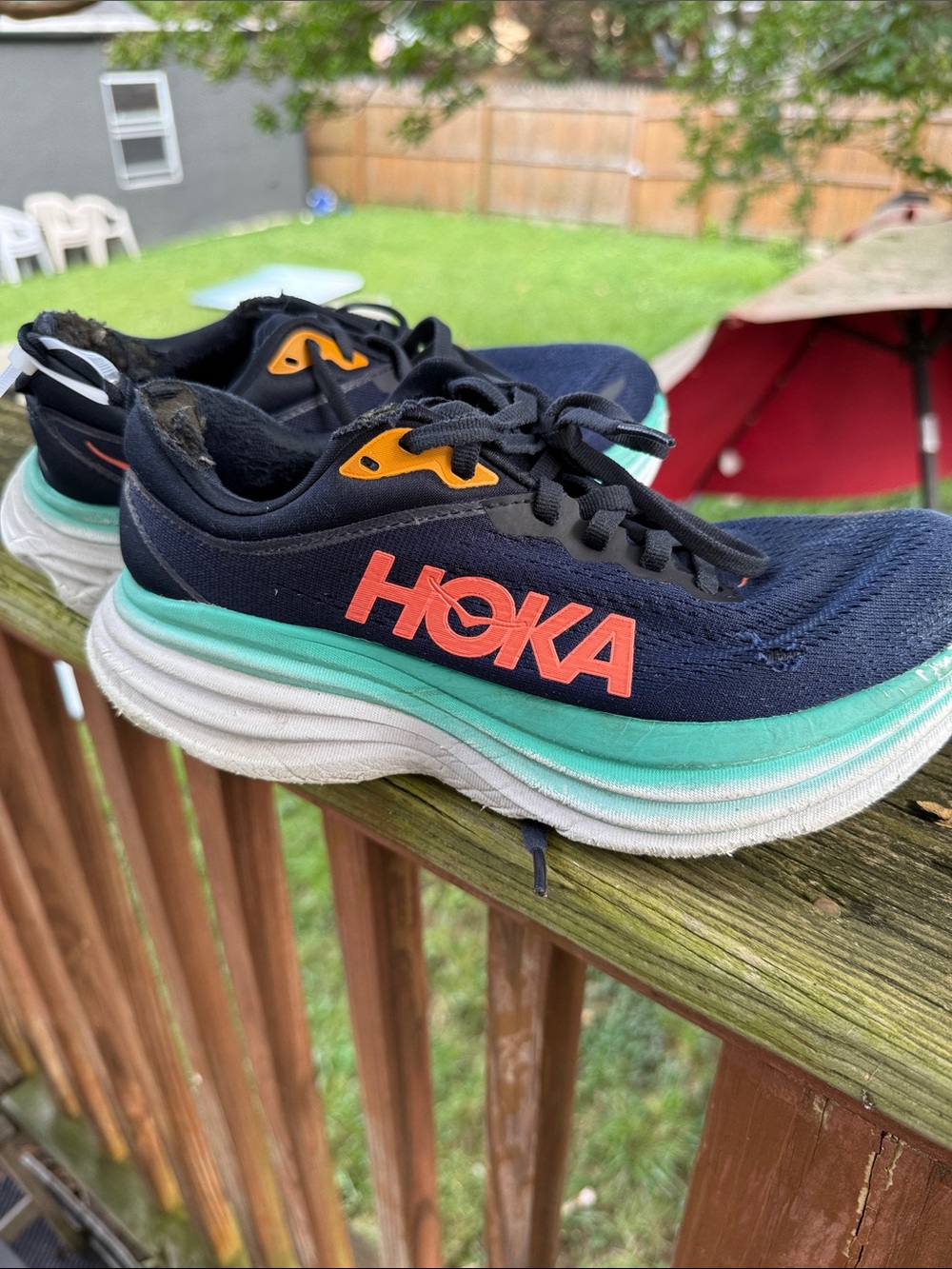 Hoka women’s Navy Sneakers with Teal Midsole and Coral Logo